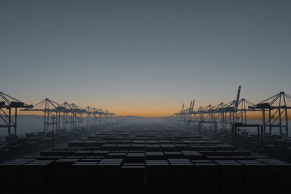 Shipping containers and gantry cranes at a port terminal at dusk